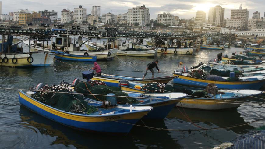 Palestinian fishermen ride in fishing boats at Gaza Seaport in Gaza City November 25, 2012. Israel eased restrictions on Gaza fishermen on Saturday, further implementing a three-day-old truce brokered by Egypt after a week of fierce fighting, Palestinian officials said. REUTERS/Mohammed Salem (GAZA - Tags: POLITICS CIVIL UNREST TPX IMAGES OF THE DAY) - RTR3AUHV