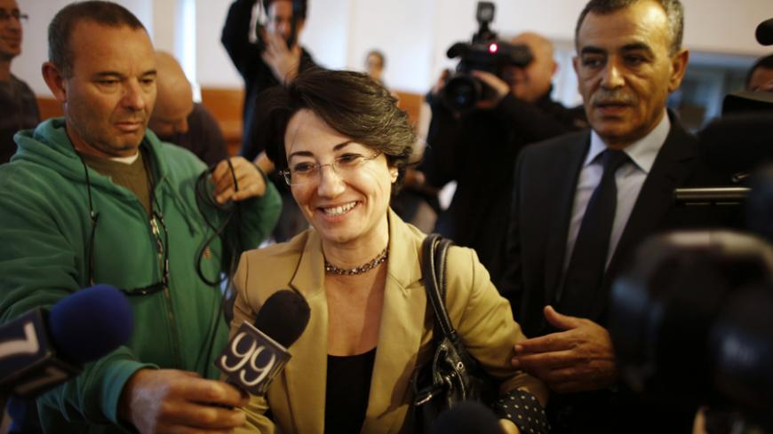 Israeli Arab lawmaker Haneen Zoabi (C) speaks to the media as she enters a hearing at the Supreme Court in Jerusalem December 27, 2012. Zoabi appealed to the Supreme Court after Israel's electoral authority barred her from re-election on December 19, saying she had supported the nation's enemies by joining a protest ship that tried to break a naval blockade of Gaza. REUTERS/Ammar Awad (JERUSALEM - Tags: POLITICS) - RTR3BXBD