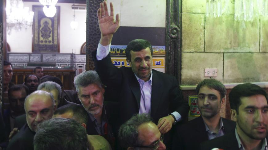 Iran's President Mahmoud Ahmadinejad (C) waves near the shrine (L) of Prophet Mohammed's grandson Hussein ibn Ali at the Al-Hussein mosque, named after the grandson, in old Cairo February 5, 2013. Ahmadinejad was both kissed and scolded on Tuesday when he began the first visit to Egypt by an Iranian president since Tehran's 1979 Islamic revolution. The trip was meant to underline a thaw in relations since Egyptians elected an Islamist head of state, President Mohamed Mursi, last June. But it also highlighte