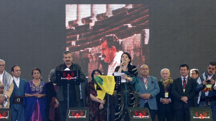 Pro-Kurdish politicians Sirri Sureyya Onder (3rd L) and Pervin Buldan (6th R) read the statement of jailed Kurdish rebel leader Abdullah Ocalan as they are flanked by other Kurdish politicians during a gathering to celebrate Newroz in the southeastern Turkish city of Diyarbakir March 21, 2013. Ocalan ordered his fighters on Thursday to cease fire and withdraw from Turkish soil as a step to ending a conflict that has killed 40,000 people, riven the country and battered its economy. Hundreds of thousands of K