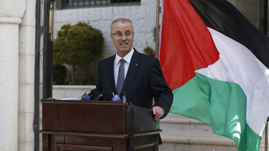 Palestinian Prime Minister Rami Hamdallah talks to media after the first unity government meeting in the West Bank city of Ramallah June 3, 2014. President Barack Obama's administration said on Monday it plans to work with and fund the new Palestinian unity government, and Israel immediately voiced its disappointment with the decision also criticized by some U.S. lawmakers. REUTERS/Mohamad Torokman (WEST BANK - Tags: POLITICS) - RTR3RY8D