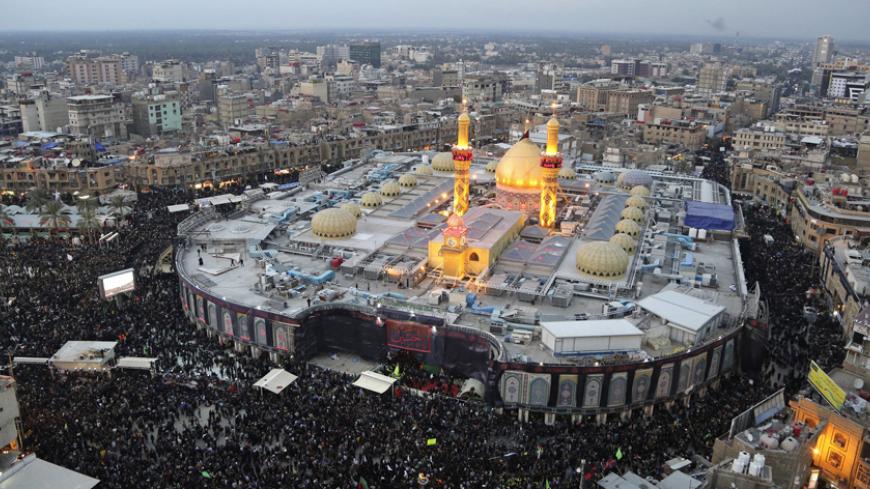 An aerial view shows the Shrine of Imam al-Abbas during the commemoration of Arbain in Kerbala, southwest of Baghdad December 13, 2014. Iraqi officials say millions of Shi'ite pilgrims from across Iraq and neighbouring countries are expected in Kerbala for Saturday's Arbain ritual, which marks the last of 40 days of mourning for the death of Imam Hussein that happened around 1,300 years ago. REUTERS/Abdul-Zahra (IRAQ - Tags: RELIGION SOCIETY CITYSCAPE) - RTR4HW0P