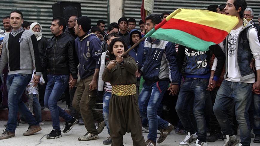 A Kurdish boy waves a Kurdish flag during celebrations after it was reported that Kurdish forces took control of the Syrian town of Kobani, in Sheikh Maksoud neighborhood of Aleppo January 27, 2015. Kurdish forces battled Islamic State fighters outside Kobani on Tuesday, a monitoring group said, a day after Kurds said they took full control of the northern Syrian town following a four-month battle. REUTERS/Hosam Katan  (SYRIA - Tags: POLITICS CIVIL UNREST CONFLICT) - RTR4N52W
