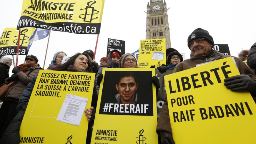 Ensaf Haidar (C) takes part in a demonstration calling for the release of her husband, Raif Badawi, on Parliament Hill in Ottawa January 29, 2015. Ensaf Haidar, the wife of a Saudi rights activist, who was sentenced to 1,000 lashes last year, said Thursday her husband's health had worsened after the first round of flogging and that he could not possibly survive the full punishment. REUTERS/Chris Wattie (CANADA - Tags: POLITICS CIVIL UNREST CRIME LAW) - RTR4NIK2