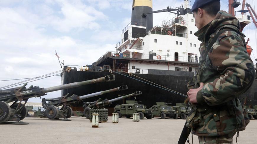 A Lebanese soldier stands guard in front of a ship that delivered military donation from the U.S. government to the Lebanese army, during a ceremony at Beirut's port February 8, 2015. More than 70 M198 Howitzers, as well as 26 million rounds of ammunition including small, medium, and heavy artillery rounds, were delivered on Sunday  from the United States as military aid to the Lebanese army. REUTERS/Mohamed Azakir (LEBANON - Tags: POLITICS MILITARY) - RTR4OOO9