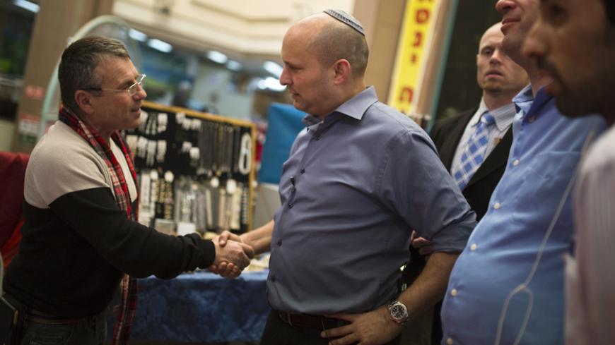 Israel's Economy Minister Naftali Bennett (R), head of the far-right Jewish Home party, shakes hands with a Russian-speaking immigrant as he campaigns in the southern city of Ashkelon February 3, 2015. In this seaside city once ruled by the Greeks and Phoenicians but now largely populated by Russians, the talk in the caviar-stocked delis and jewellery stores is of upcoming elections and Israel's powerful Russian vote. Given that Soviet migrants make up 20 percent of Israel's Jewish population, their conserv
