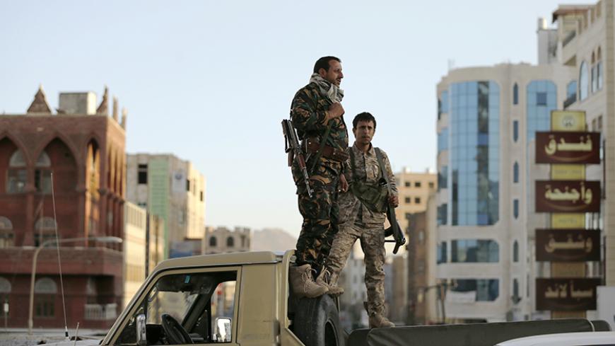 Houthi fighters stand on a truck as they secure a street where pro-Houthi protesters demonstrated to commemorate the fourth anniversary of the uprising that toppled former President Ali Abdullah Saleh in Sanaa February 11, 2015. REUTERS/Khaled Abdullah (YEMEN - Tags: POLITICS CIVIL UNREST MILITARY) - RTR4P71Q