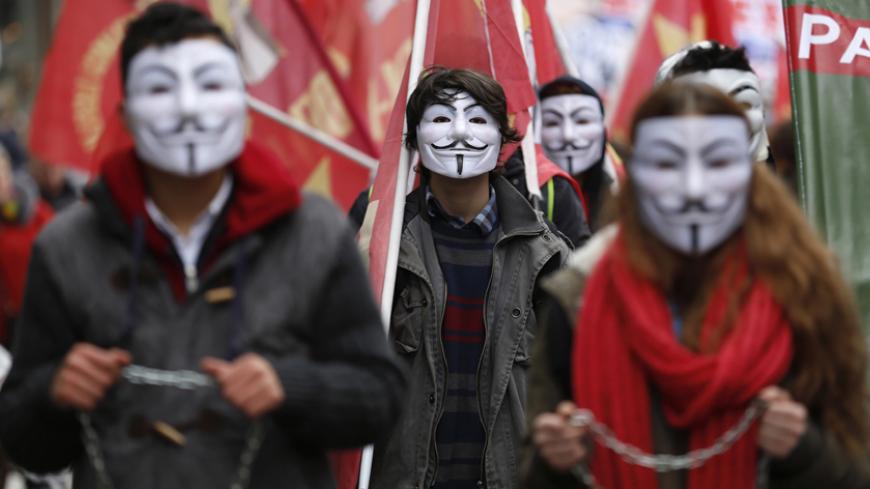 High school students wearing Guy Fawkes masks take part in a protest against the education policies of the ruling AK Party in Istanbul February 13, 2015. Education is the latest flashpoint between the administration of President Tayyip Erdogan, and secularist Turks who accuse him of overseeing creeping 'Islamisation' in the NATO member state. Parts of some regular schools have been requisitioned to create more places for students in "Imam Hatip" religious schools championed by Erdogan, where girls and boys 