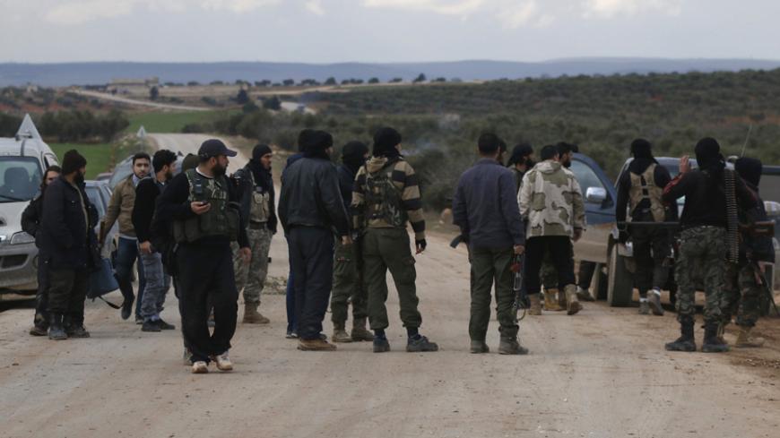 Rebel fighters gather near the front line in Ratain village, north of Aleppo February 17, 2015. The Syrian army backed by allied militia have captured several villages near Aleppo in battles aimed at encircling the northern city and cutting off insurgent supply lines, a monitoring group said on Tuesday. The army also took villages including Bashkuwi and Sifat, while fighting raged in Hardatain and Ratain, said the Observatory, which tracks the Syrian conflict using sources on the ground. It added that at le