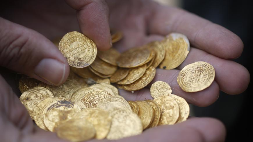 Ancient gold coins are displayed in Caesarea, north of Tel Aviv along the Mediterranean coast February 18, 2015. Almost 2,000 gold coins, believed to be from the 11th century, were found in recent weeks on the seabed by amateur divers who then alerted the Israel Antiquities Authority's Marine Archaeology Unit. 
REUTERS/Nir Elias (ISRAEL - Tags: MARITIME SOCIETY) - RTR4Q2KJ