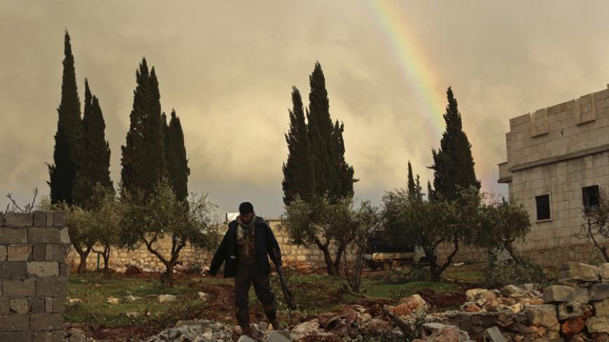 A rebel fighter carries his weapon as he walks in front of a rainbow in Ratian village, north of Aleppo, after what the rebels said was an offensive against them by forces loyal to Syria's President Bashar al-Assad that attempted to advance in the village but failed to February 18, 2015. Battles in and around the Syrian city of Aleppo have killed at least 70 pro-government fighters and more than 80 insurgents after the army launched an offensive there, a monitoring group said on Wednesday. Picture taken Feb