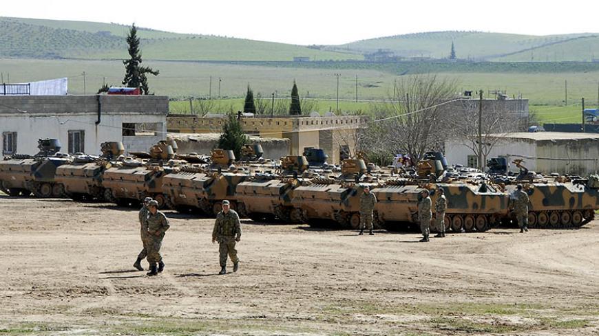 Turkish military armored vehicles, which took part in an operation inside Syria, are pictured near the Mursitpinar border crossing in the southeastern town of Suruc, Sanliurfa province, February 23, 2015. A Turkish military operation to rescue 38 soldiers guarding a tomb in Syria surrounded by Islamic State militants was launched to counter a possible attack on them, presidential spokesman Ibrahim Kalin said on Monday. The action, which involved tanks, drones and reconnaissance planes as well as several hun