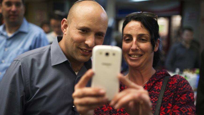 Israel's Economy Minister Naftali Bennett (L), head of far-right Jewish Home party, poses for a picture with a supporter as he campaigns in the southern city of Ashkelon February 3, 2015. Young and ambitious, with a ready smile and a quick wit, Israeli far right leader Naftali Bennett is on a mission to prevent the creation of a Palestinian state. If, as widely expected, he takes on defence or another key portfolio after next month's election, that mission will take a big step closer to fulfilment, somethin