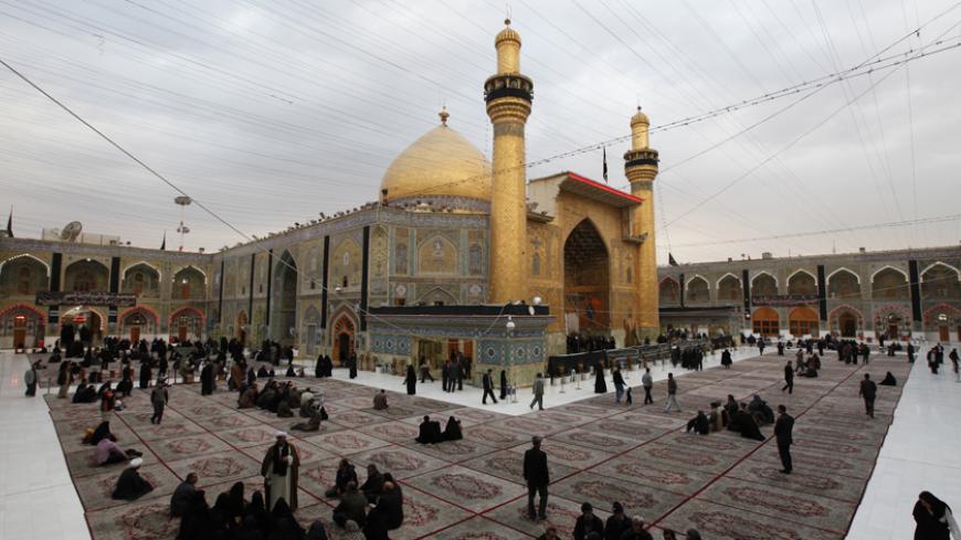 Shi'ite Muslims attend a religious ritual at the Imam Ali shrine in Najaf, 160 km (100 miles) south of Baghdad, January 8, 2011.  REUTERS/Mohammed Ameen (IRAQ - Tags: RELIGION POLITICS) - RTXWC4X