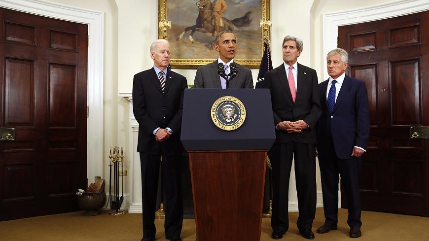 U.S. President Barack Obama is flanked by Vice President Joe Biden (L), Secretary of State John Kerry (2nd R) and Defense Secretary Chuck Hagel (R) as he delivers a statement on legislation sent to Congress to authorize the use of military force against the Islamic State, from the Roosevelt Room at the White House in Washington February 11, 2015. Obama asked Congress on Wednesday to authorize military force against Islamic State that would bar any large-scale invasion by U.S. ground troops and limit operati