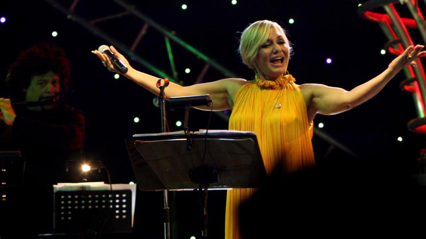 Iranian singer Googoosh, whose real name is Faegheh Atashin, salutes the audience during a rare concert she gave in the Iraqi Kurdish city of Arbil, 320 kms (200 miles) north of Baghdad, late on September 12, 2010. The popular Persian diva was banned from singing along with all female preformers in Iran after the establishment of the Islamic republic in 1979, but she resumed her performances abroad ten years ago.  AFP PHOTO/SAFIN HAMED (Photo credit should read SAFIN HAMED/AFP/Getty Images)