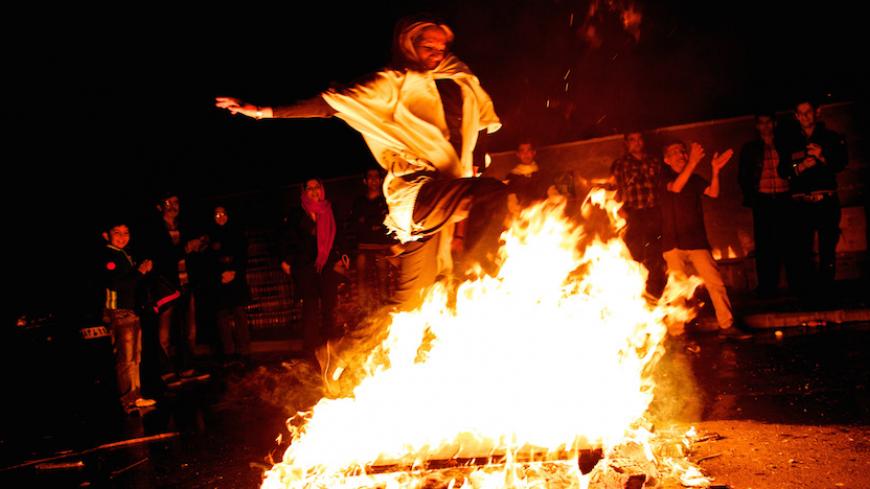 An Iranian woman jumps over a bonfire in southern Tehran on March 19, 2013 during the Wednesday Fire feast, or Chaharshanbeh Soori, held annually on the last Wednesday eve before the Spring holiday of Noruz. The Iranian new year that begins on March 20 coincides with the first day of spring during which locals revive the Zoroastrian celebration of lighting a fire and dancing around the flame. AFP PHOTO/BEHROUZ MEHRI        (Photo credit should read BEHROUZ MEHRI/AFP/Getty Images)
