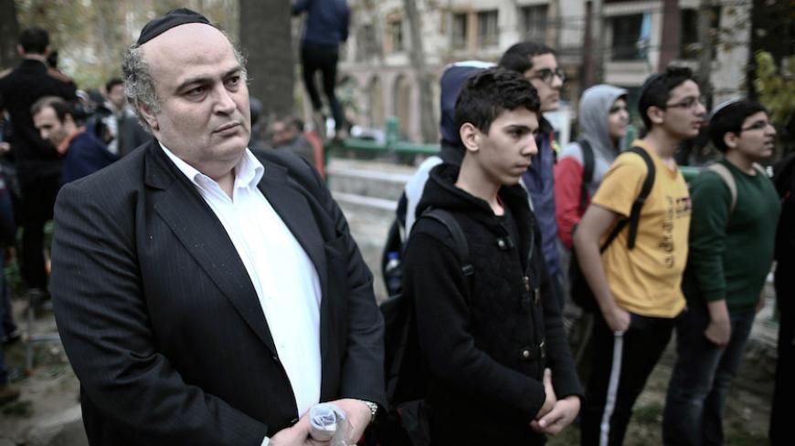 Iranian Jewish MP Siamak Moreh Sedq (L) and schoolboys read prayers during a demonstration in front of the United Nation's building in Tehran on November 19, 2013 in support of Iran's nuclear program and Iranian negotiators on the eve of the new round of nuclear talks with world powers in Geneva. Talks are scheduled to restart on November 20, as the P5+1 group aims to convince Iran to roll back its work that Western power suspect is masking a military nuclear drive in exchange for some sanctions relief. AFP