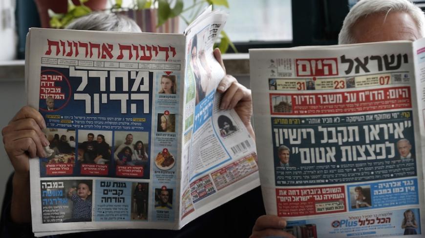 TO GO WITH AFP STORY BY JEAN-LUC RENAUDIE - Men read Israeli newspapers, paying daily Yedioth Aharonot (L) and free daily Israel HaYom (R) in Jerusalem, on February 25, 2015. As politicians intensify their campaigning for Israeli snap elections, an equally ferocious battle is playing out between two media tycoons -- a friend and a foe of Prime Minister Benjamin Netanyahu.  AFP PHOTO / THOMAS COEX        (Photo credit should read THOMAS COEX/AFP/Getty Images)