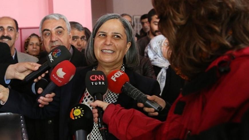 Gulten Kisanak, the Peace and Democracy party candidate campaigning to be Mayor of Diyarbakir, speaks with journalists after casting her ballot in Diyarbakir on March 30, 2014, during municipal elections in Turkey ahead of a presidential vote in six months and parliamentary polls next year. Turkey's Premier Recep Tayyip Erdogan, embattled by protests and corruption scandals, faced a crucial popularity test today when over 50 million eligible voters cast their ballots in local elections. More than 50 million