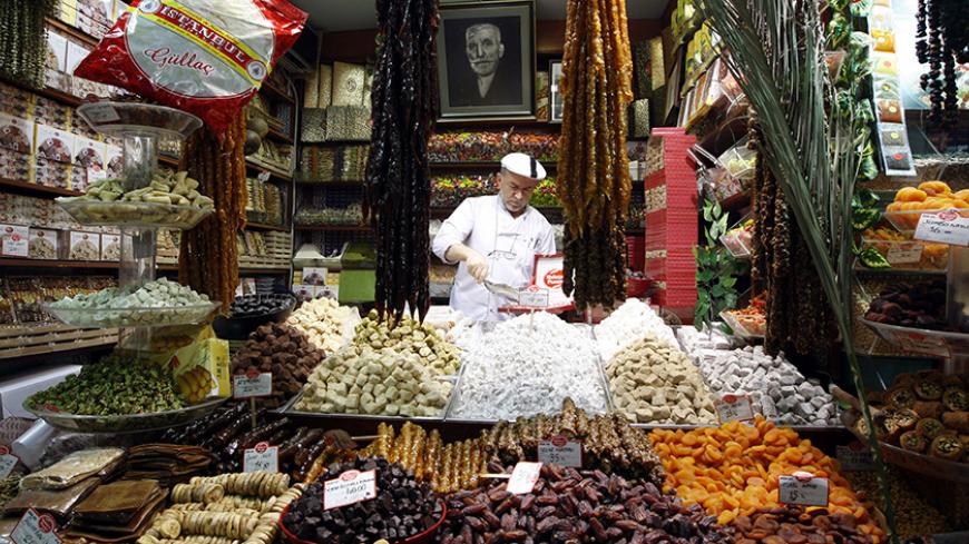A Turkish vendor sells dates and dried fruits at the Ottoman-era spice market known as the Egyptian Bazaar during preparations for the upcoming holy month of Ramadan, in Istanbul August 20, 2009. Muslims around the world abstain from eating, drinking and conducting sexual relations from sunrise to sunset during Ramadan, the holiest month in the Islamic calendar. REUTERS/Murad Sezer (TURKEY RELIGION IMAGES OF THE DAY) - RTR26XKO