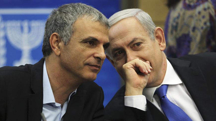 Moshe Kahlon, Israel's Communications and Social Welfare Minister (L) speaks with Prime Minister Benjamin Netanyahu during a Likud party meeting at the Knesset, the Israeli parliament, in Jerusalem October 15, 2012. Netanyahu's Likud party suffered a setback to its popularity on Monday following the announcement by Kahlon, one of the party's best appreciated ministers, that he would step down after an upcoming general election. REUTERS/Baz Ratner (JERUSALEM - Tags: POLITICS) - RTR3966V