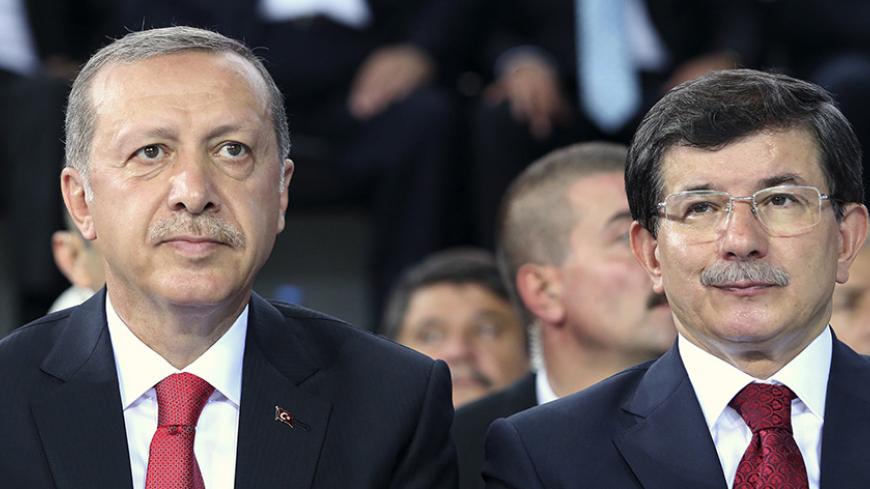 Turkey's Prime Minister Tayyip Erdogan (L) and Foreign Minister Ahmet Davutoglu attend the Extraordinary Congress of the ruling AK Party (AKP) to choose a new leader of the party, ahead of Erdogan's inauguration as president, in Ankara August 27, 2014. Turkish president-elect Erdogan said on Wednesday he would ask incoming prime minister Ahmet Davutoglu to form a new government on Thursday, and a new cabinet of ministers would be announced the following day.   REUTERS/Rasit Aydogan/Pool  (TURKEY - Tags: POL