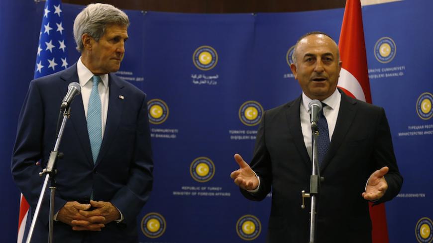 U.S. Secretary of State John Kerry (L) and Turkey's Foreign Minister Mevlut Cavusoglu talk to the media before a meeting in Ankara September 12, 2014. Kerry will meet Cavusoglu, as well as Prime Minister Ahmet Davutoglu and President Tayyip Erdogan during his two-day visit to the capital Ankara, the Turkish Foreign Ministry said. REUTERS/Umit Bektas (TURKEY - Tags: POLITICS) - RTR45Z12