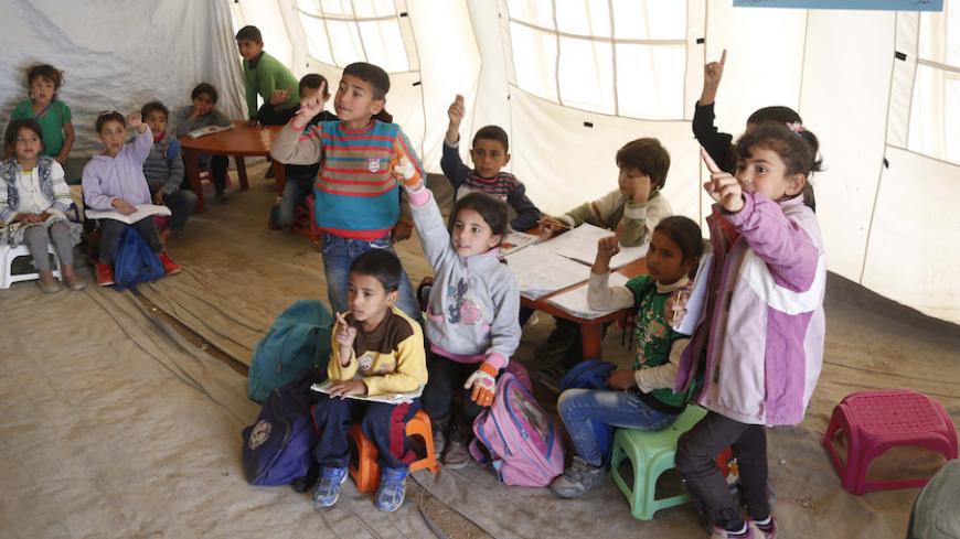 Syrian refugee children attend a class inside a makeshift school, supported by UNICEF and in cooperation with the Beyond Association, in Zahle in the Bekaa valley October 22, 2014. REUTERS/Mohamed Azakir (LEBANON - Tags: EDUCATION SOCIETY IMMIGRATION CIVIL UNREST POVERTY) - RTR4B6RH