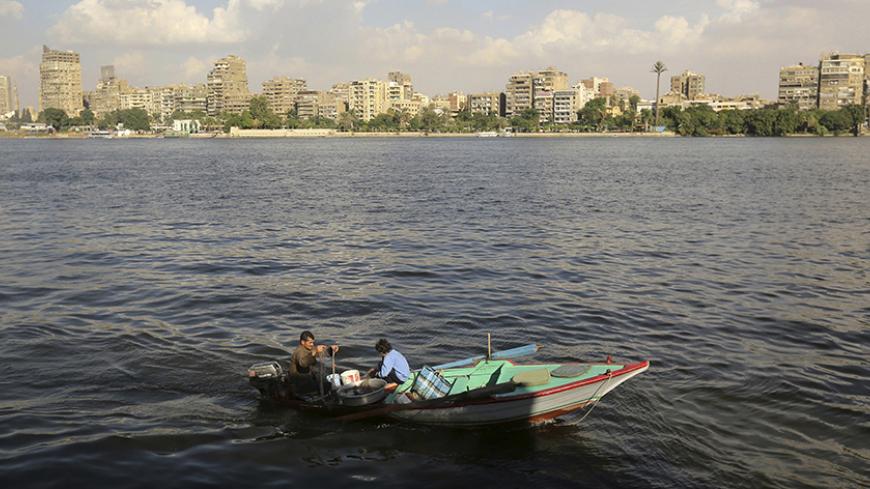 A fisherman rows his boat with his family on the river Nile in Cairo October 30, 2014. REUTERS/Mohamed Abd El Ghany (EGYPT - Tags: SOCIETY) - RTR4C8V2