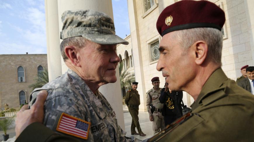 Iraq's army chief General Babakir Zebari (R) meets with U.S. Army General Martin Dempsey, chairman of the Joint Chiefs of Staff, at the defence ministry in Baghdad November 15, 2014. The top U.S. military officer, Dempsey, arrived on Saturday in Baghdad on an unannounced visit as U.S. commanders prepare to expand American assistance to Iraqi and Kurdish forces battling the Islamic State.   REUTERS/Stringer (IRAQ - Tags - Tags: CIVIL UNREST POLITICS MILITARY) - RTR4E9AP