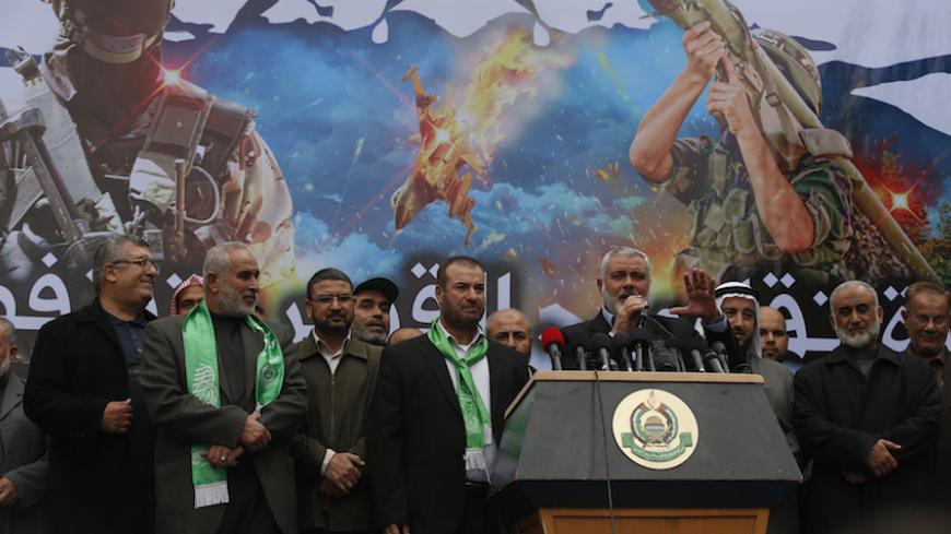 Senior Hamas leader Ismail Haniyeh (5th R) gestures as he gives a speech during a rally ahead of the 27th anniversary of Hamas founding, in Jabaliya in the northern Gaza Strip December 12, 2014.  REUTERS/Mohammed Salem (GAZA - Tags: POLITICS CIVIL UNREST) - RTR4HR3K