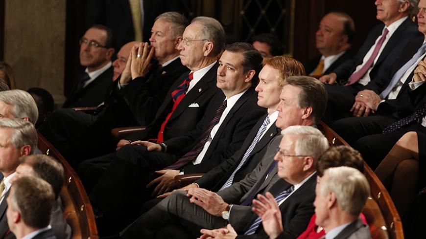 U.S. Rep. Ted Cruz (R-TX) (C) and Republican congressional colleagues listen as U.S. President Barack Obama delivers his State of the Union address to a joint session of the U.S. Congress on Capitol Hill in Washington, January 20, 2015. REUTERS/Larry Downing (UNITED STATES  - Tags: POLITICS)   - RTR4M87B