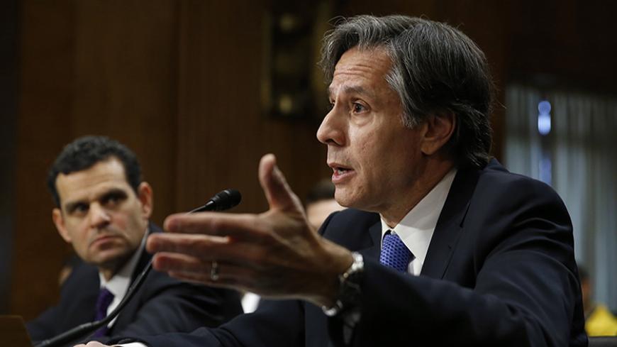 U.S. Deputy Secretary of State Antony Blinken (R) and Treasury Under Secretary for Terrorism and Financial Intelligence David Cohen (L) testify before the Senate Foreign Relations Committee in Washington January 21, 2015. Top U.S. Treasury and State Department officials said on Wednesday that, despite reports, Russia had not entered into oil-for-goods deals with Iran in violation of international sanctions.  REUTERS/Gary Cameron   (UNITED STATES - Tags: POLITICS BUSINESS) - RTR4MCBJ