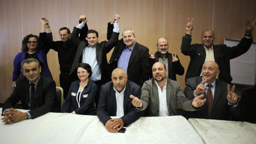 Arab-Israeli parliament members and other candidates join their hands after it was announced that a joint political slate of all the Arab parties will be running in the upcoming elections, during a news conference in Nazareth,  January 23, 2015. Four political parties that mostly represent Israel's Arab minority have decided to run together in elections on March 17, creating a potential counter-weight to Prime Minister Benjamin Netanyahu and his right-wing allies. Opinion polls suggest the united Arab list 