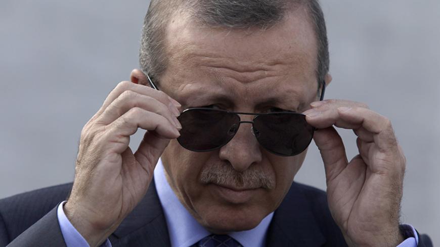 Turkey's President Recep Tayyip Erdogan adjusts his sunglasses before a wreath-laying ceremony at the Jose Marti monument in Havana February 11, 2015. Erdogan is in Cuba for an official visit. REUTERS/Enrique De La Osa (CUBA - Tags: POLITICS) - RTR4P6U8