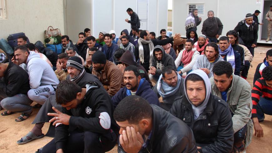 A group of Egyptian illegal immigrants, who according to authorities will be deported back to Egypt through the border with Tunisia on Wednesday, are seen being held at the Alkarareem immigration centre in the east of Misrata February 18, 2015. REUTERS/Stringer (LIBYA - Tags: POLITICS SOCIETY IMMIGRATION) - RTR4Q60O