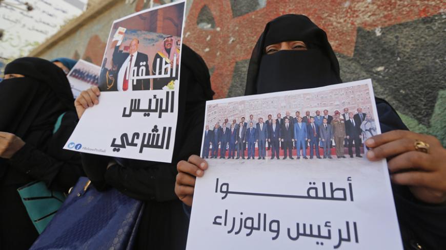 Women take part in an anti-Houthi demonstration in Sanaa February 21, 2015. Yemen's former president Abd-Rabbu Mansour Hadi left his official residence after weeks of house arrest by the Houthi militia on Saturday and flew to his home town of Aden, witnesses and a political source said. The posters read: "Release the legitimate president!" (L) and "Release the president and ministers!" REUTERS/Khaled Abdullah (YEMEN - Tags: POLITICS CIVIL UNREST MILITARY) - RTR4QI2I
