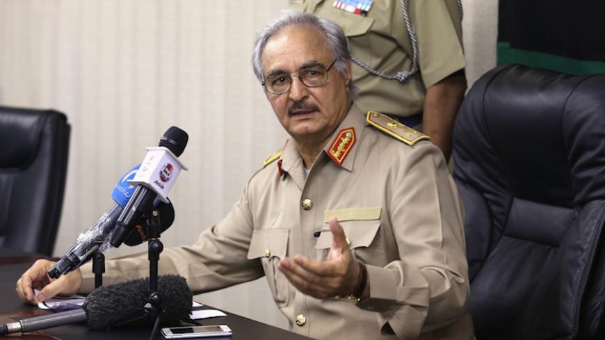 Then-General Khalifa Haftar speaks during a news conference in Abyar, east of Benghazi May 31, 2014. Growing frustration over the reality of life in eastern Libya, which contrasts with the promises of politicians, is feeding support for Haftar, who has set himself up as a warrior against Islamist militancy and who some also see as their saviour.  Picture taken May 31, 2014.    REUTERS/Esam Omran Al-Fetori (LIBYA - Tags: CIVIL UNREST POLITICS MILITARY) - RTR4QLUA
