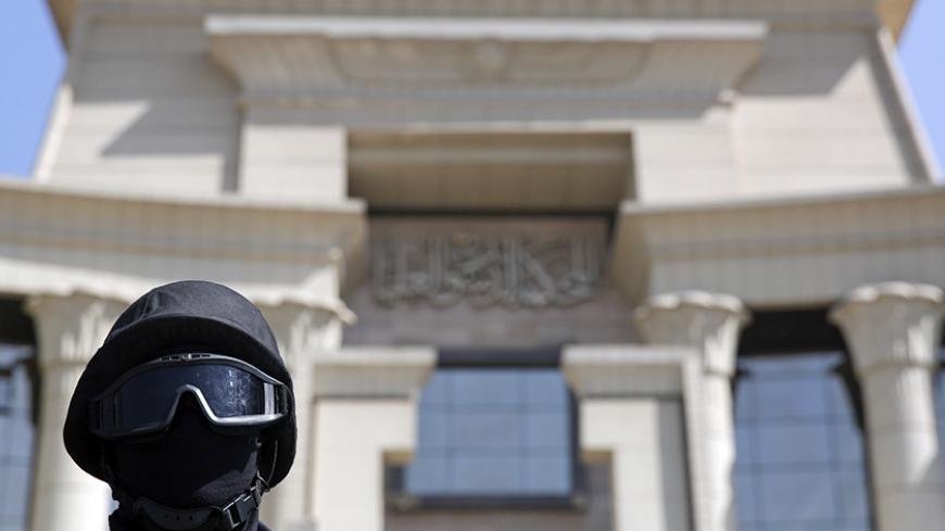 A member of the special forces police stands guard in front of the Supreme Constitutional Court in Cairo, March 1, 2015, during a court session to determine if the House of Representatives parliamentary election law is constitutional. Egypt's Supreme Election Committee said on Sunday it was working on a "new timetable" for holding a parliamentary election. Earlier the Supreme Constitutional Court had ruled that an article related to a law defining electoral districts was unconstitutional, opening the way fo