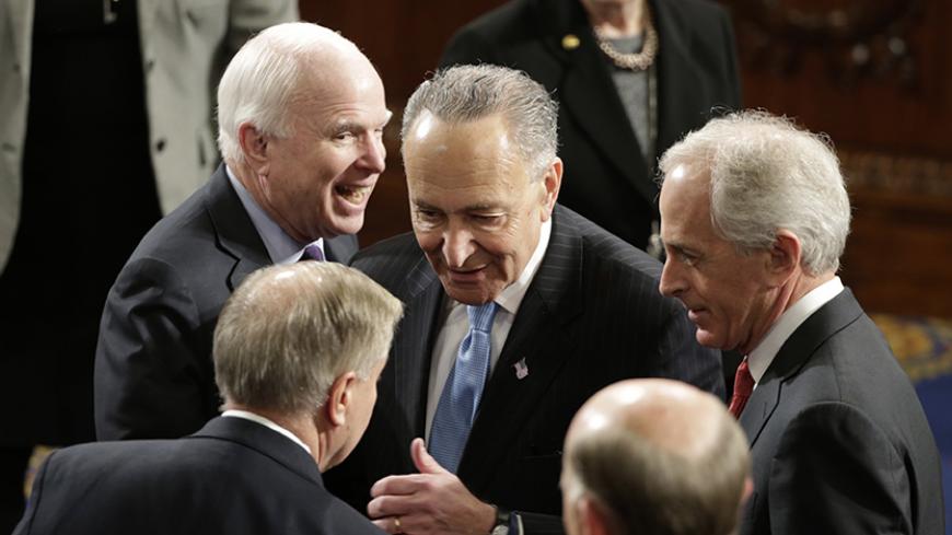 U.S. Senators' Lindsey Graham (front L) (R-SC), John McCain (Back L) (R-AZ), Charles Schumer (C) (D-NY) and Bob Corker (R) (R-TN) talk on the floor of the House Chamber prior to Israeli Prime Minister Benjamin Netanyahu's address to a joint meeting of Congress in the House Chamber on Capitol Hill in Washington, March 3, 2015. REUTERS/Gary Cameron (UNITED STATES  - Tags: POLITICS)   - RTR4RX59