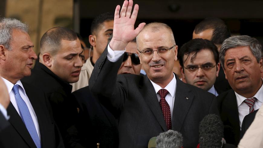 Palestinian Prime Minister Rami Hamdallah waves during a news conference in Gaza City March 25, 2015. Hamdallah, who arrived to Gaza on Wednesday, urged donor countries to fulfill their financial obligations for the reconstruction of Gaza. REUTERS/Mohammed Salem







 - RTR4UTH1
