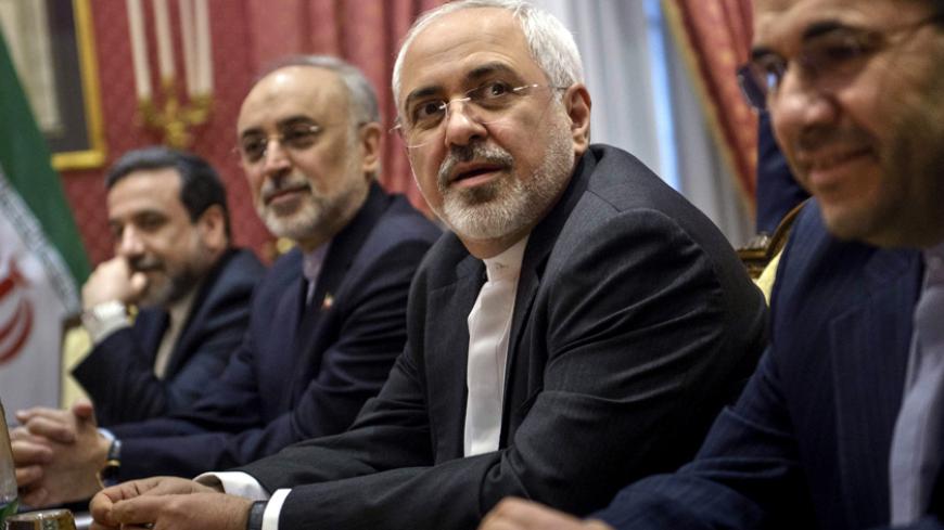 Iranian Foreign Minister Javad Zarif (2nd R) waits for the start of a meeting with a US delegation at the Beau Rivage Palace Hotel in Lausanne on March 26, 2015 during negotiations on the Iranian nuclear programme. REUTERS/Brendan Smialowski/Pool - RTR4UXL4