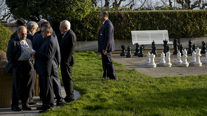 Iranian Foreign Minister Javad Zarif speaks with members of his delegation during talks at the Beau Rivage Palace Hotel in Lausanne March 27, 2015. Major powers and Iran were pushing each other for concessions on Friday ahead of an end-March deadline for a preliminary nuclear deal, with Tehran demanding an immediate end to sanctions and freedom to continue sensitive atomic research, officials said. REUTERS/Brendan Smialowski/Pool - RTR4V6PB
