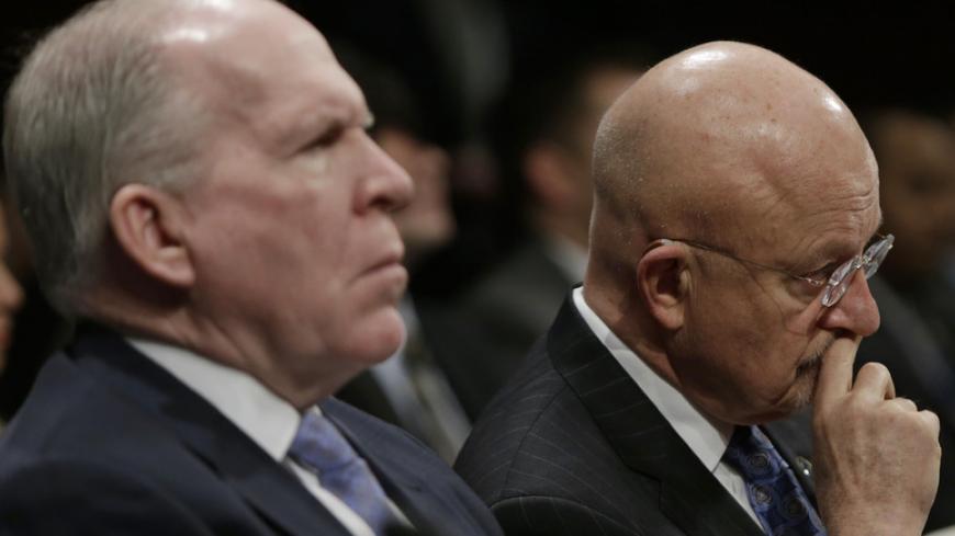 Director of U.S. National Intelligence James Clapper (R) and CIA Director John Brennan (L) listen to opening remarks at the House Intelligence Committee on "Worldwide Threats", in Washington February 4, 2014.        REUTERS/Gary Cameron  (UNITED STATES - Tags: CRIME LAW POLITICS MILITARY) - RTX187SF