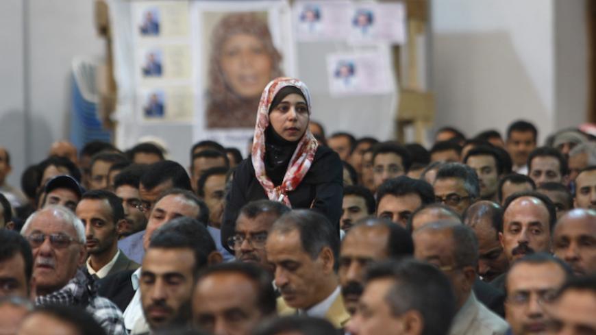 A female journalist stands among her male counterparts during the fourth congress of the Yemeni Journalists Syndicate in Sanaa March 14, 2009. Around 1,200 journalists from across Yemen attended the meeting to elect a new chairman for their syndicate and 12 members for its executive council. REUTERS/Khaled Abdullah (YEMEN MEDIA POLITICS) - RTXCRLM