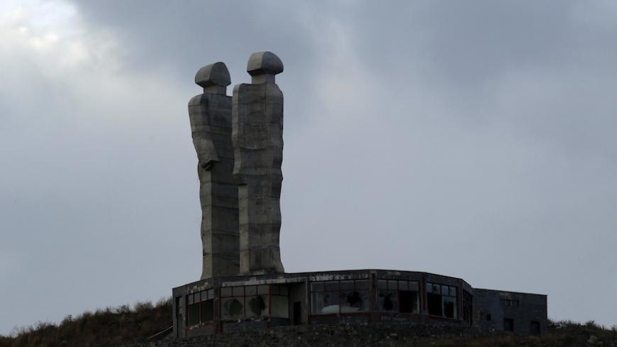 The peace monument by Turkish sculptor Mehmet Aksoy is pictured in Kars, northeastern Turkey, January 9, 2011. The fate of a giant peace monument symbolising reconciliation between Turks and Armenians has caused a row in Turkey after Prime Minister Tayyip Erdogan branded it "monstrous" and called for its demolition. The unfinished monument by renowned Turkish sculptor Aksoy consists of two concrete figures more than 30 metres high who face each other on an hill in the northeastern city of Kars. Picture take