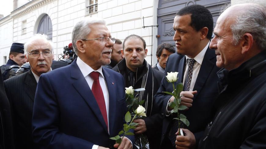 Tunisia's Foreign minister Taieb Baccouche (L) speaks with Imam of the municipal Drancy mosque in Seine-Saint-Denis, Hassen Chalghoumi (2R) on March 18 mars 2015 in front of the Tunisian embassy in Paris where people gathered in solidarity with victims of the Tunis's museum attack.  22 were killed including 20 tourists by two gunmen at Bardo International Museum on March 18, 2015 in Tunis. AFP PHOTO/FRANCOIS GUILLOT        (Photo credit should read FRANCOIS GUILLOT/AFP/Getty Images)