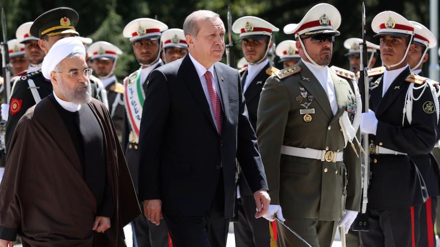 Iran's President Hassan Rouhani (L) walks with Turkish President Recep Tayyip Erdogan (C) during an official welcoming ceremony following the latter's arrival at the Saadabad Palace in Tehran on April 7, 2015, for an official one-day visit as the two countries criticized each other in recent weeks on their respective policies in the region. AFP PHOTO/ATTA KENARE        (Photo credit should read ATTA KENARE/AFP/Getty Images)