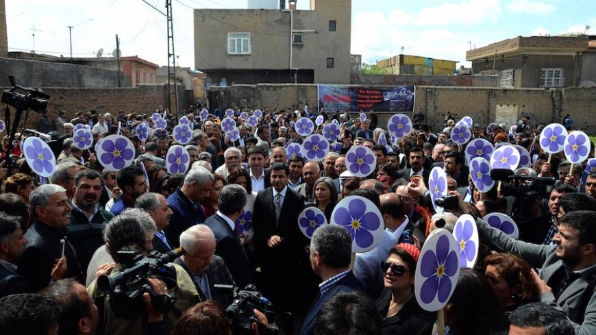 Co-leaders of the pro-Kurdish left-wing Peoples' Democracy Party (HDP) Selahattin Demirtas (C) attends a rally in front of the ruins of Surp Sarkis (Saint Sarkis) Armenian church in Diyarbakir, to commemorate the 100th anniversary of the 1915 mass killing of Armenians in the Ottoman Empire on April 24, 2015. Armenians demand that Turkey regognizes the genocide of 1,5 million of their kin killed between 1915 and 1917 by the Ottoman Empire, Turkey's predecessor. In rejecting the genocide label, Turkey says be